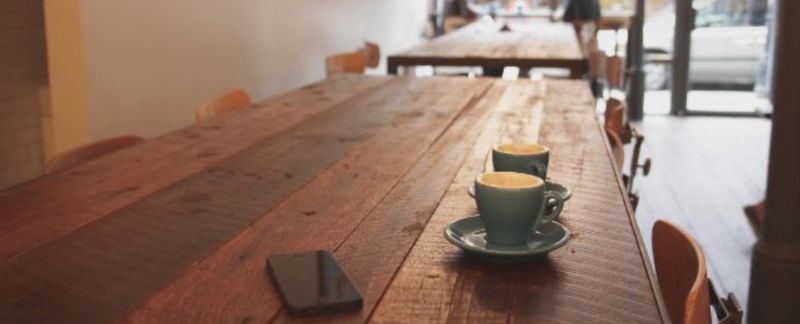 A café table with two flat whites